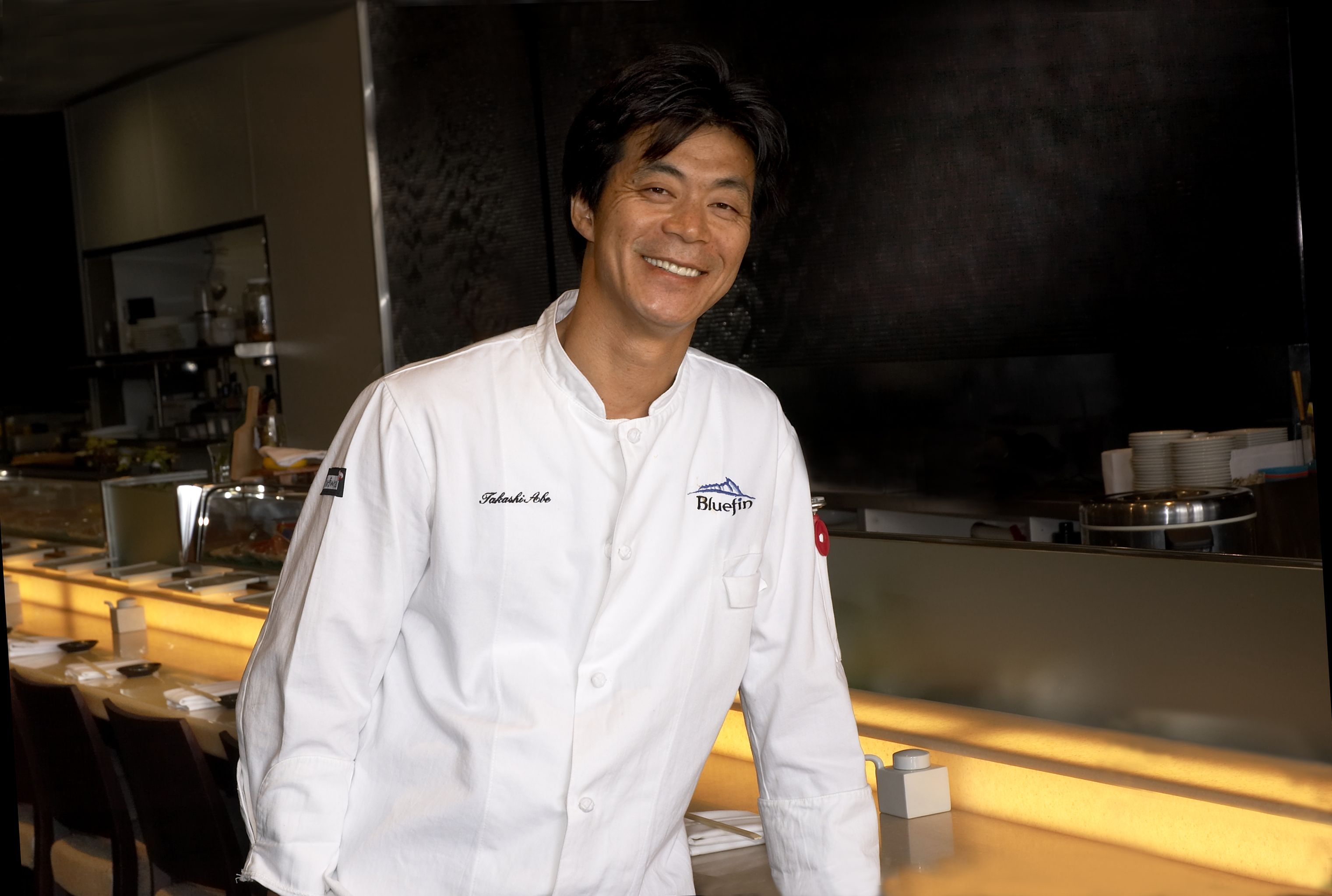 Chef Takashi Abe in his chef's whites at the Bluefin sushi bar